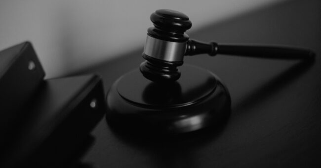 courtroom gavel image with text overlayed, "blog post: AI Governance Framework for Small Businesses"