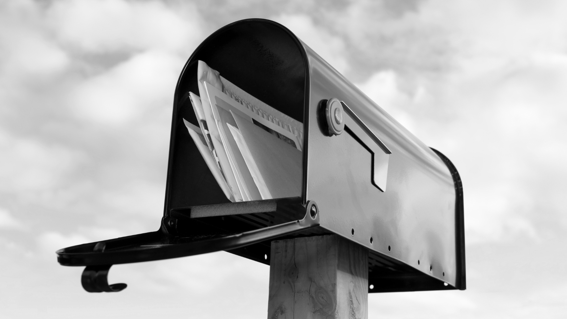 A mailbox with several letters in it